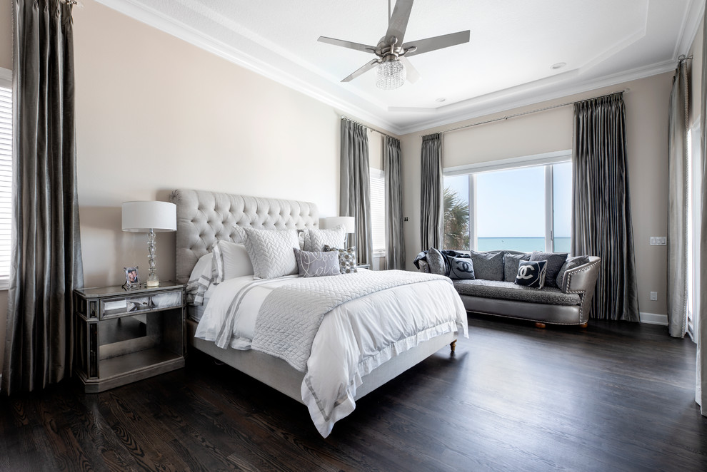 Photo of a large transitional master bedroom in Tampa with beige walls, dark hardwood floors and grey floor.
