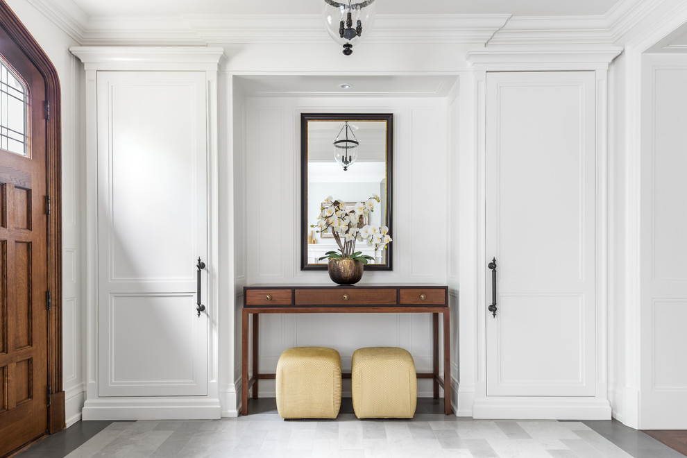 Inspiration for a large transitional marble floor foyer remodel in Toronto with gray walls and a medium wood front door