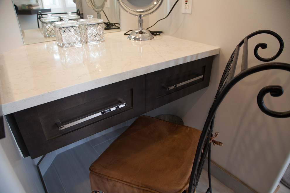 Example of a large transitional master beige tile and glass sheet porcelain tile freestanding bathtub design in Edmonton with shaker cabinets, brown cabinets, a two-piece toilet, beige walls, an undermount sink and quartz countertops