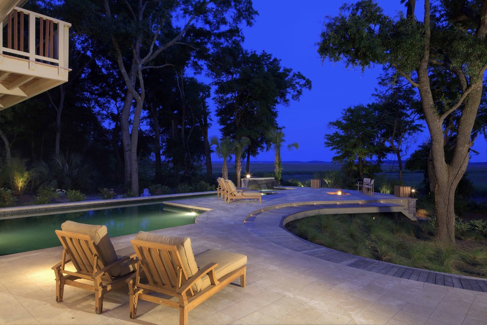 Photo of a large contemporary backyard custom-shaped pool in Atlanta with natural stone pavers and a hot tub.