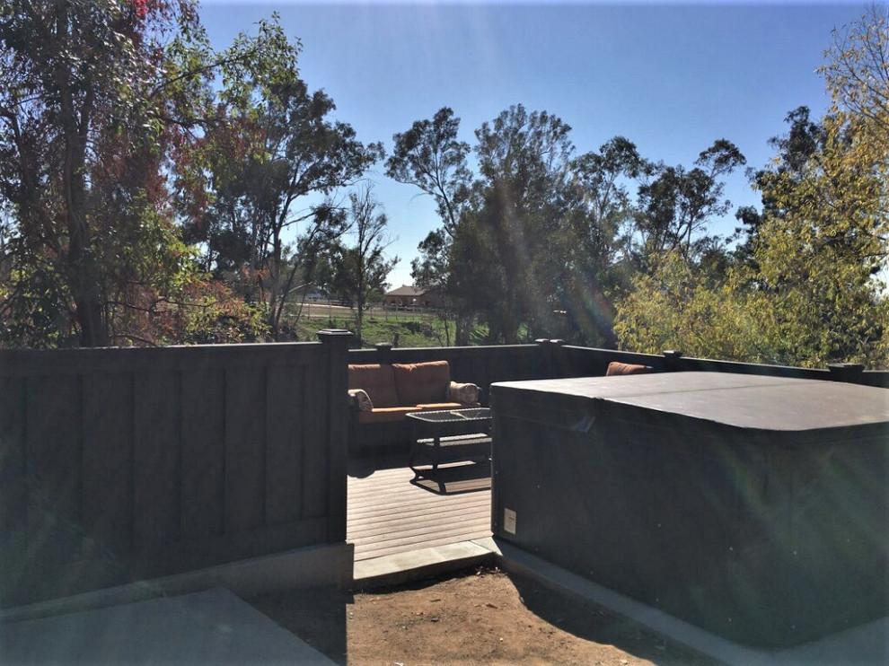 This is an example of a mid-sized beach style backyard deck in Los Angeles with with privacy feature.