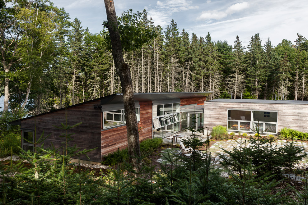 Inspiration for a contemporary exterior in Portland Maine with wood siding and a shed roof.