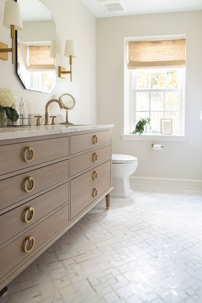 Mid-sized transitional master bathroom in Philadelphia with flat-panel cabinets, brown cabinets, an alcove shower, a one-piece toilet, marble, marble floors, an undermount sink, marble benchtops, white floor, a hinged shower door, white benchtops, a niche, a double vanity and a freestanding vanity.