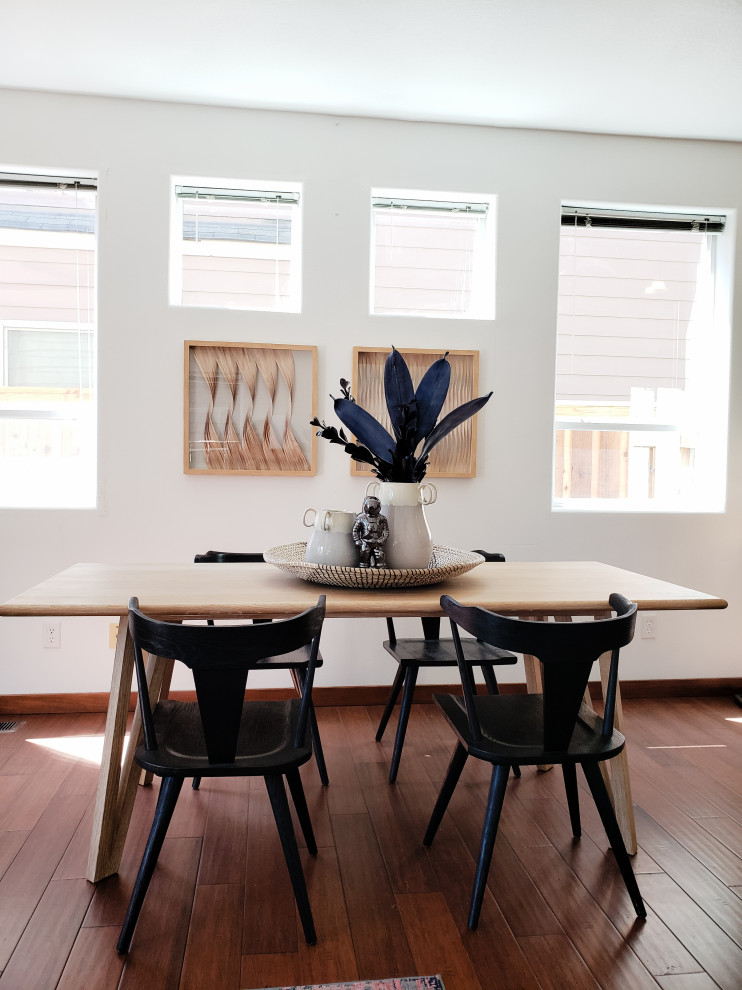 Small midcentury dining room in Portland with white walls, light hardwood floors, beige floor and vaulted.