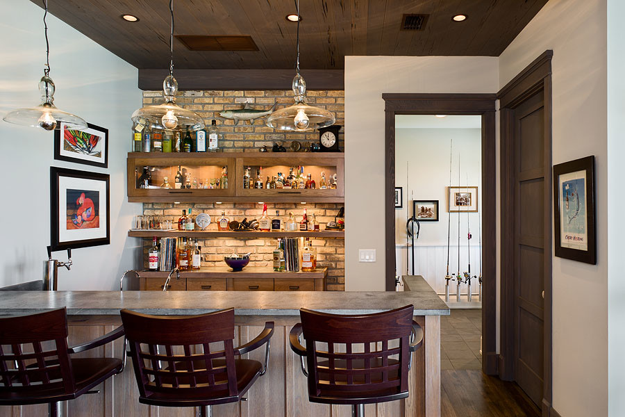 Inspiration for a mid-sized beach style single-wall seated home bar in Tampa with glass-front cabinets, medium wood cabinets, brick splashback and medium hardwood floors.