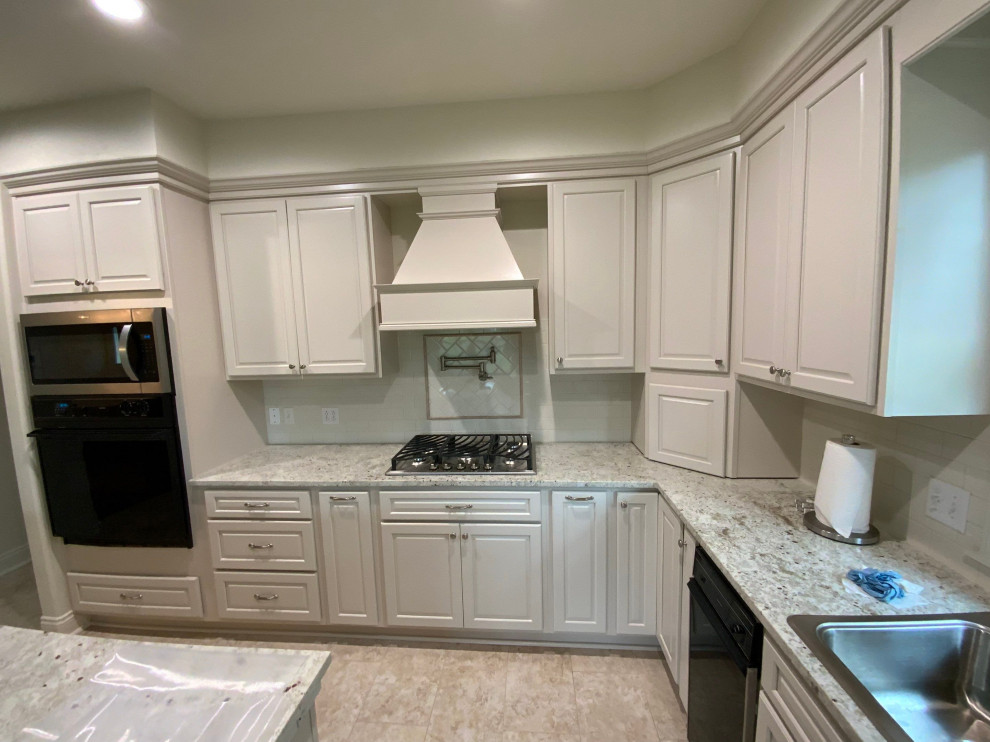 Eat-in kitchen - l-shaped ceramic tile and beige floor eat-in kitchen idea with a double-bowl sink, white cabinets, granite countertops, white backsplash, subway tile backsplash, stainless steel appliances, an island and gray countertops