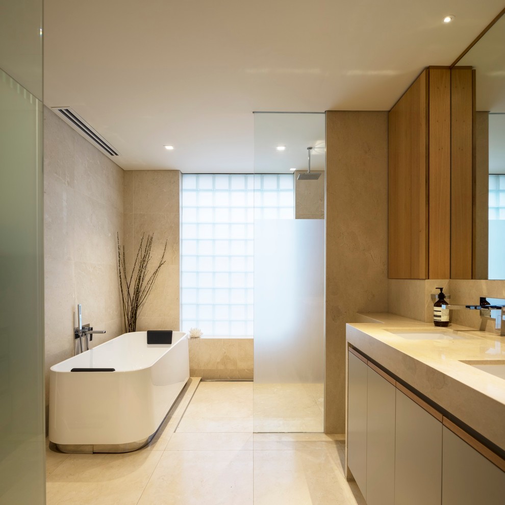 Mid-sized modern bathroom in Sydney with flat-panel cabinets, a freestanding tub, an open shower, beige tile, beige walls and an open shower.