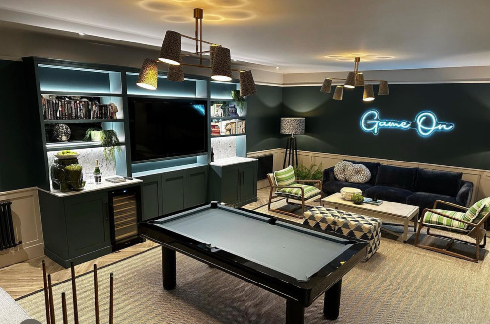 This is an example of a modern family room in Hertfordshire with a game room.