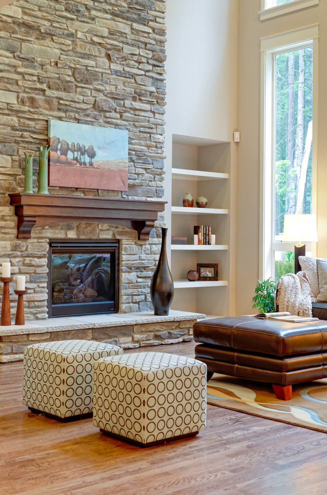 Traditional living room in Seattle with a standard fireplace and a stone fireplace surround.