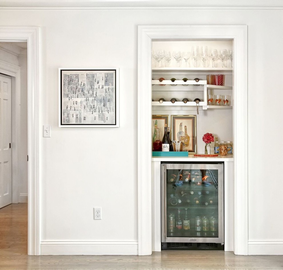 Transitional home bar in New York with open cabinets, white cabinets, light hardwood floors and beige floor.
