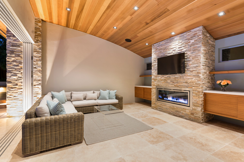 Mid-sized modern open concept family room in San Francisco with multi-coloured walls, limestone floors, a standard fireplace, a metal fireplace surround and a wall-mounted tv.