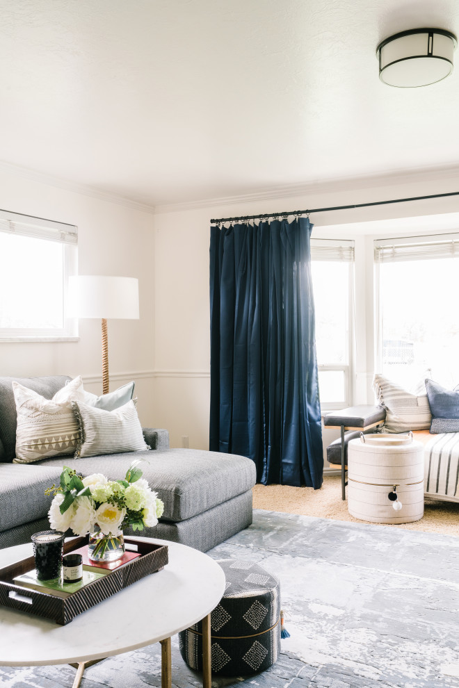 Inspiration for a mid-sized eclectic open concept family room in Salt Lake City with white walls, carpet, a corner fireplace, a brick fireplace surround, a wall-mounted tv and beige floor.