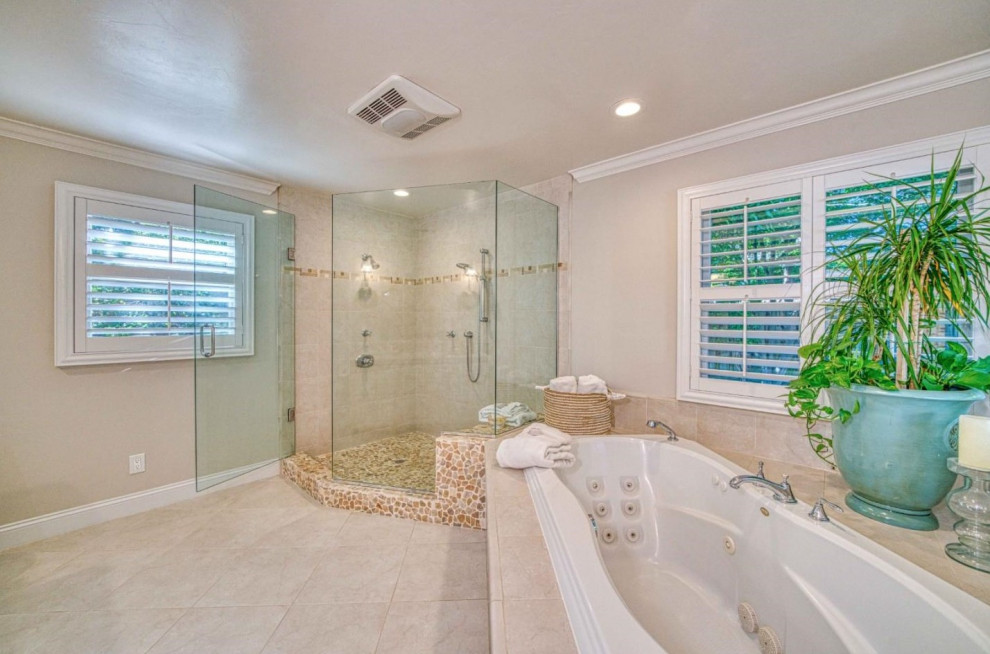 Large arts and crafts bathroom in San Francisco with beige walls, medium hardwood floors, beige floor, a drop-in tub, a double shower, beige tile, ceramic tile, a hinged shower door and a shower seat.