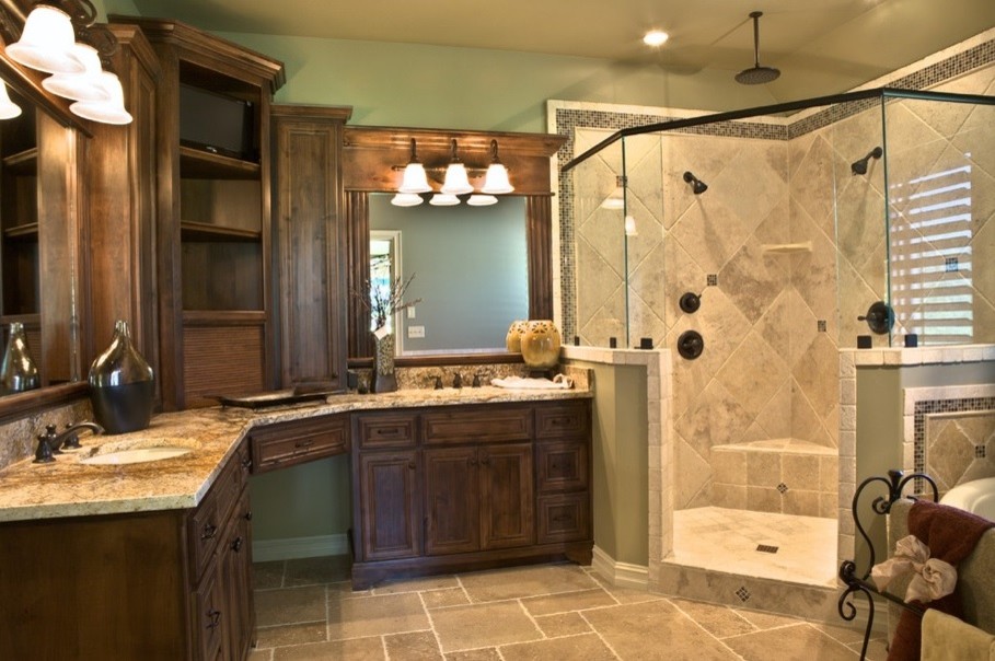 This is an example of a mid-sized mediterranean master bathroom in Houston with an undermount sink, an open shower, travertine floors, raised-panel cabinets, dark wood cabinets, a freestanding tub, green walls and a hinged shower door.