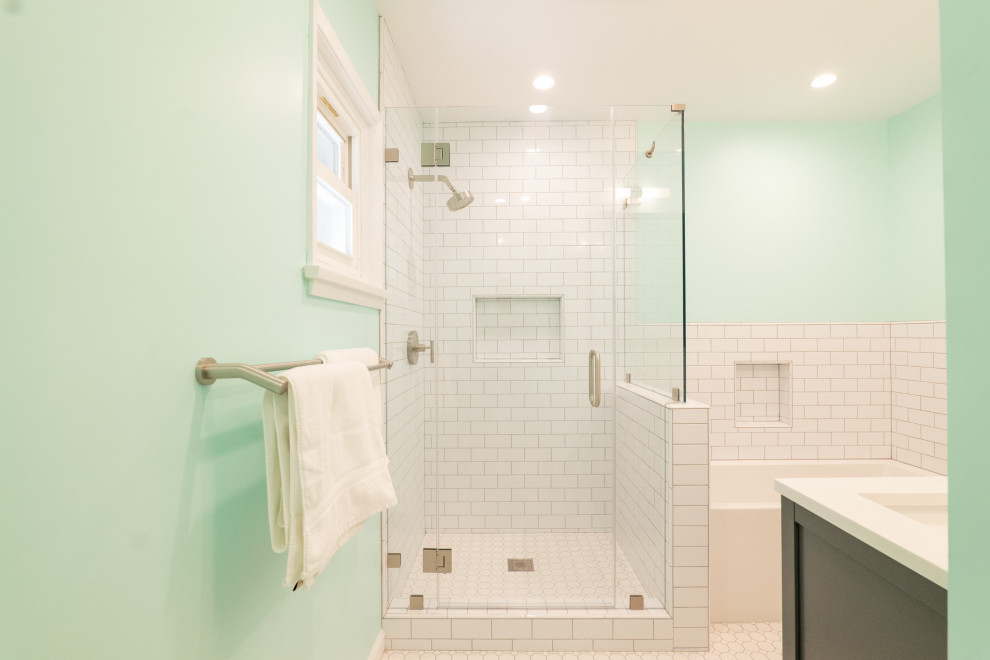 Photo of a medium sized classic ensuite bathroom in Los Angeles with raised-panel cabinets, dark wood cabinets, a submerged bath, a corner shower, a one-piece toilet, white tiles, metro tiles, green walls, cement flooring, a built-in sink, quartz worktops, white floors, a hinged door, white worktops, a wall niche, double sinks and a freestanding vanity unit.