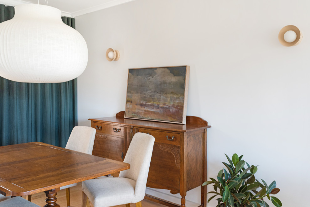 Inspiration for a midcentury dining room in Canberra - Queanbeyan with light hardwood floors and brown floor.