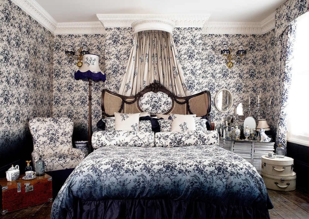 Photo of a traditional bedroom in London with blue walls and dark hardwood floors.
