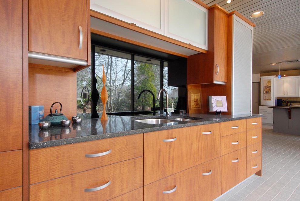 This is an example of a mid-sized modern u-shaped eat-in kitchen in Boston with a double-bowl sink, flat-panel cabinets, light wood cabinets, tile benchtops, grey splashback, stone tile splashback, stainless steel appliances, ceramic floors, with island and grey floor.