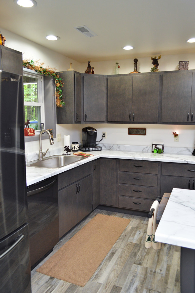 This is an example of a mid-sized contemporary l-shaped open plan kitchen in Other with a drop-in sink, flat-panel cabinets, grey cabinets, laminate benchtops, laminate floors, with island, grey floor and yellow benchtop.