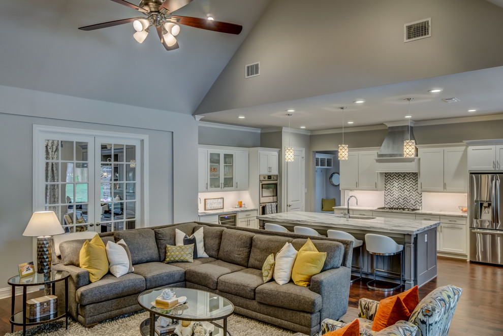 This is an example of a large transitional open concept living room in Dallas with grey walls, medium hardwood floors and brown floor.