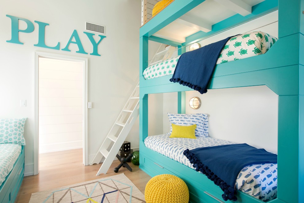 Inspiration for a mid-sized beach style gender-neutral kids' bedroom for kids 4-10 years old in Boston with white walls and medium hardwood floors.