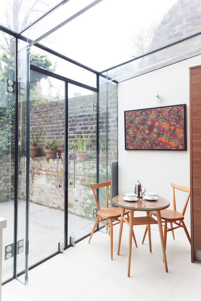 Photo of a contemporary dining room in London with white walls and white floor.