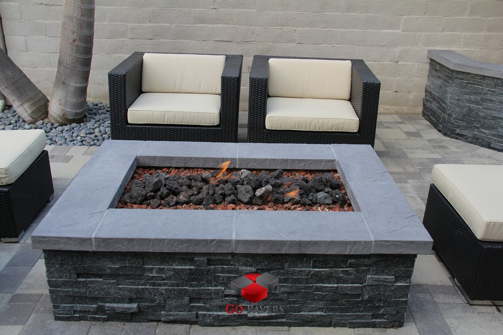 This is an example of a small contemporary backyard patio in Los Angeles with a fire feature and concrete pavers.