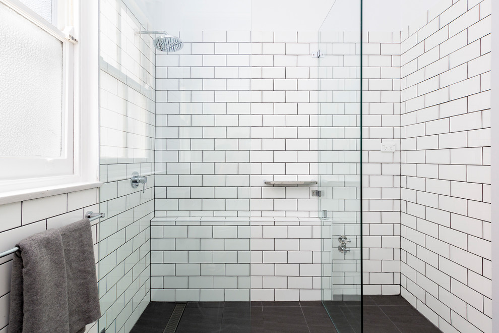 Inspiration for a small contemporary bathroom in Wollongong with furniture-like cabinets, white cabinets, an open shower, a one-piece toilet, white tile, white walls, porcelain floors, black floor, an open shower and subway tile.