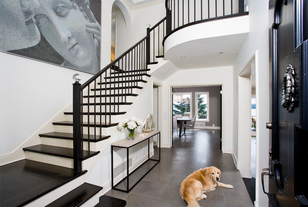 Traditional entryway in Seattle with a black front door and grey floor.