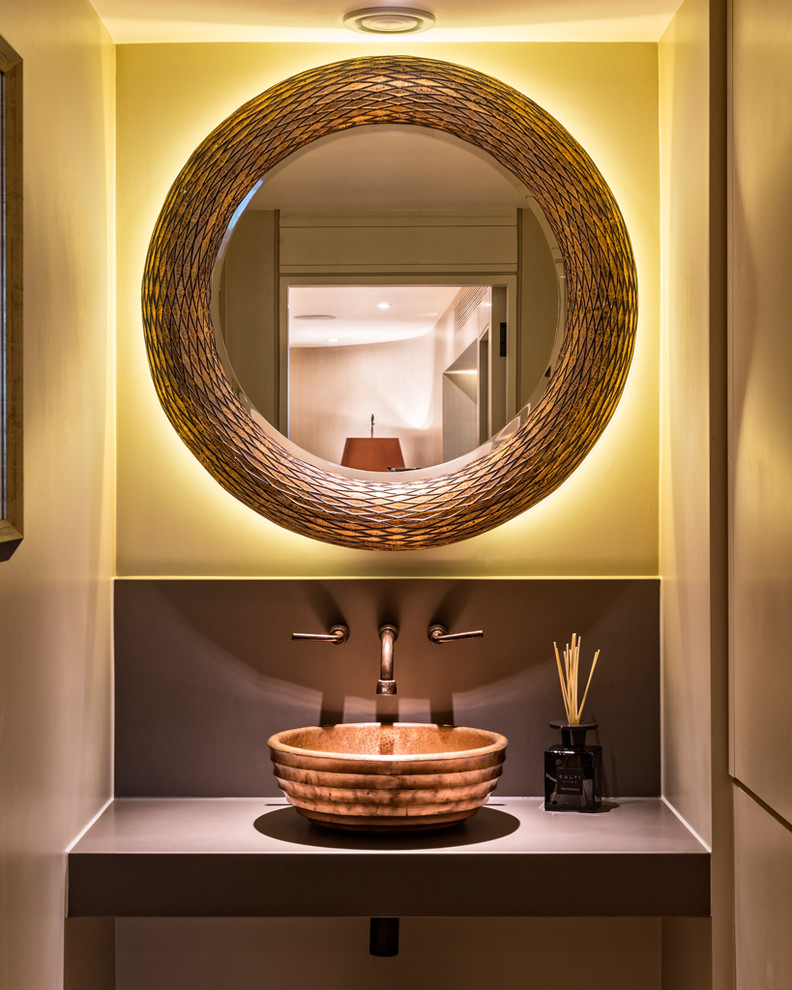 Photo of a contemporary powder room in London with beige walls.