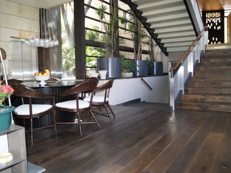Photo of a traditional dining room in Miami with dark hardwood floors.