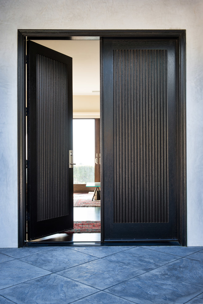 Inspiration for a contemporary front door in Melbourne with white walls, granite floors, a double front door, a dark wood front door and grey floor.