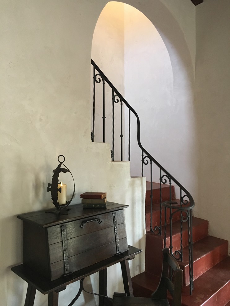 Inspiration for a large concrete l-shaped staircase in Phoenix with concrete risers and metal railing.