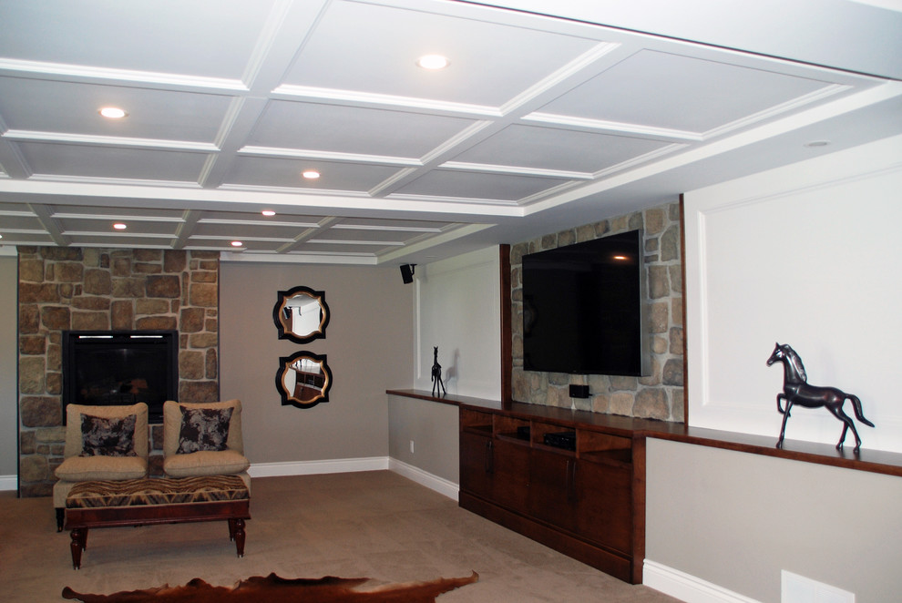 Photo of a large contemporary walk-out basement in Toronto with beige walls, carpet, a standard fireplace and a stone fireplace surround.