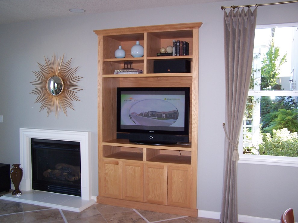 Photo of a mid-sized traditional loft-style living room in Sacramento with grey walls, a standard fireplace, a wood fireplace surround and a built-in media wall.