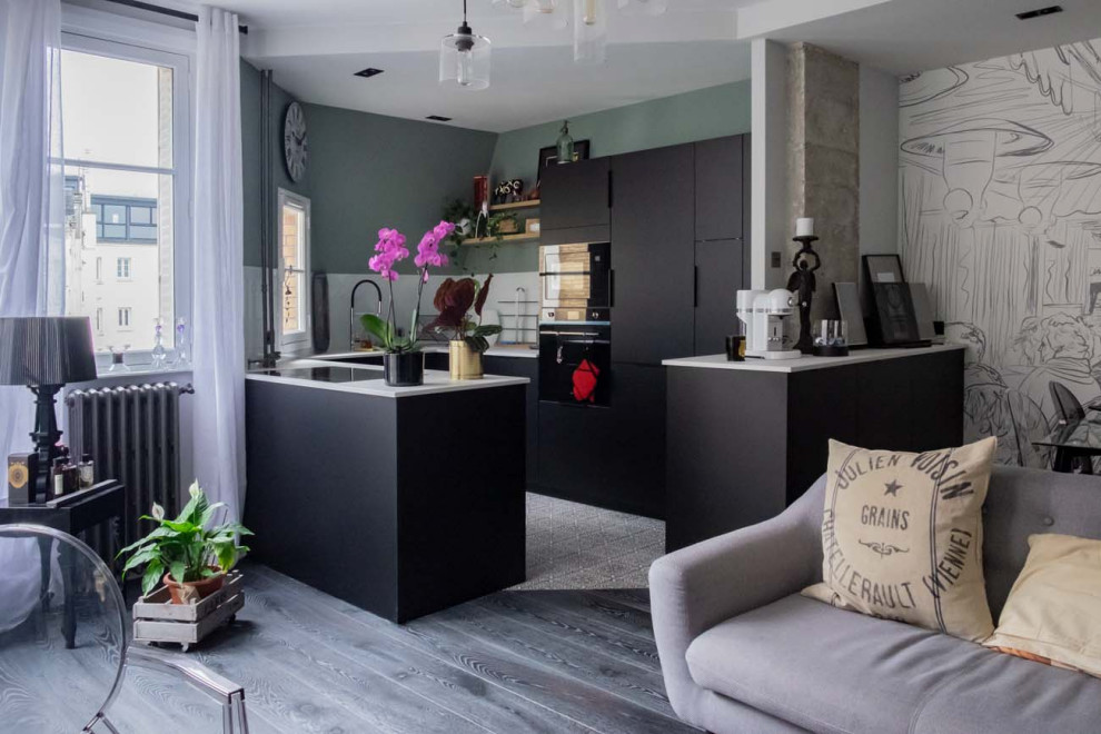 Design ideas for a mid-sized contemporary u-shaped open plan kitchen in Paris with an undermount sink, beaded inset cabinets, solid surface benchtops, white splashback, glass sheet splashback, black appliances, a peninsula, white benchtop, painted wood floors and black floor.