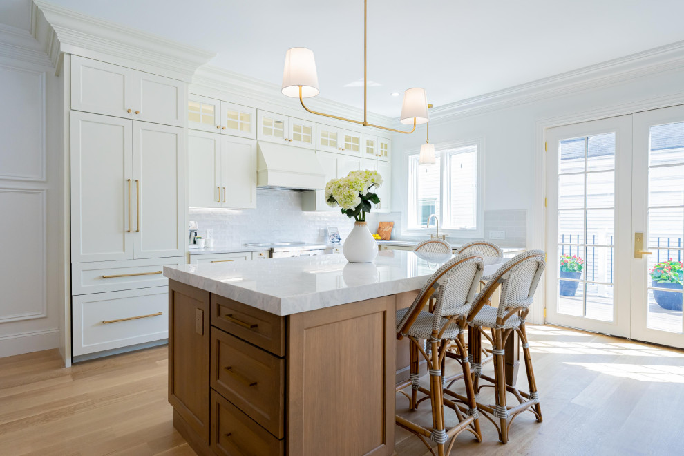 Example of a transitional kitchen design with an island