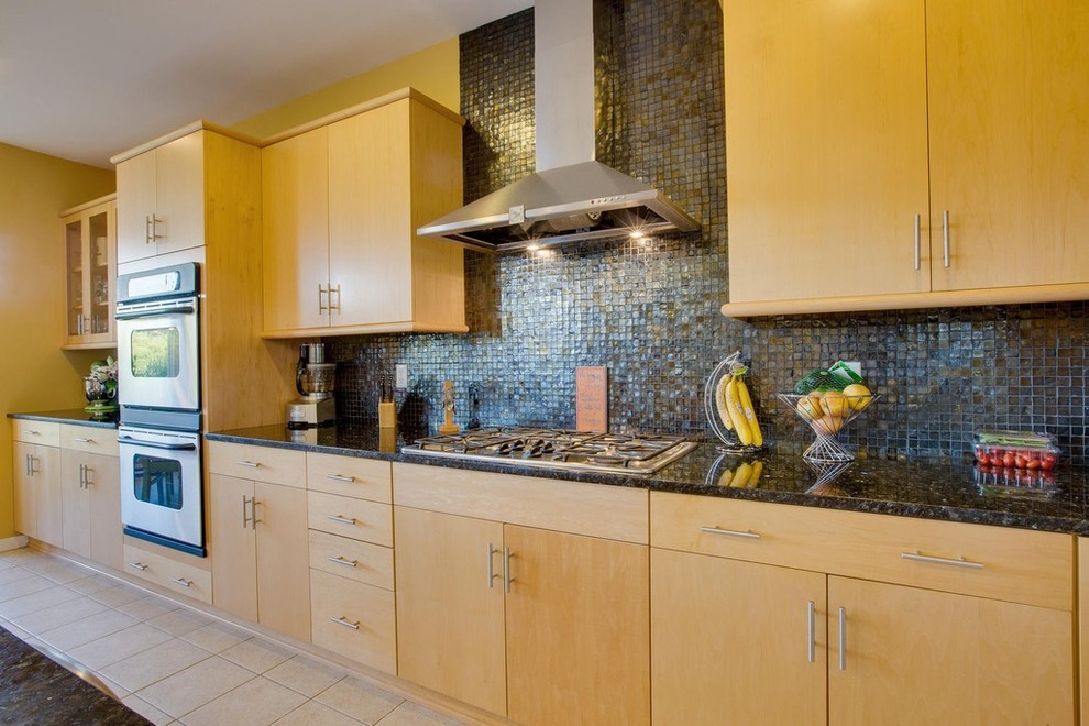Photo of a mid-sized single-wall open plan kitchen in Detroit with light wood cabinets, blue splashback, mosaic tile splashback and stainless steel appliances.
