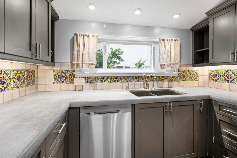 Design ideas for a small traditional u-shaped kitchen in San Francisco with an undermount sink, shaker cabinets, distressed cabinets, concrete benchtops, ceramic splashback, stainless steel appliances, medium hardwood floors, brown floor and grey benchtop.