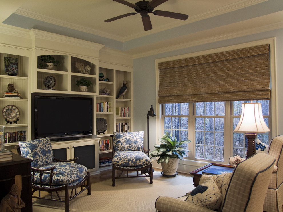 Design ideas for a beach style family room in Charlotte with a built-in media wall and blue walls.