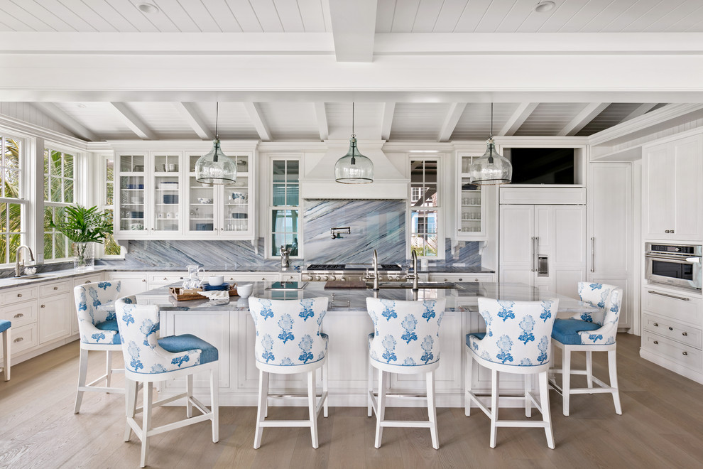 Photo of a beach style u-shaped eat-in kitchen in Tampa with beaded inset cabinets, white cabinets, quartzite benchtops, multi-coloured splashback, stone slab splashback, with island and multi-coloured benchtop.