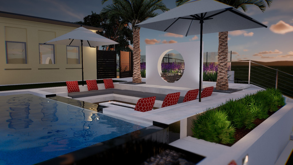 Foto di una grande piscina a sfioro infinito minimal rettangolare dietro casa con paesaggistica bordo piscina e piastrelle