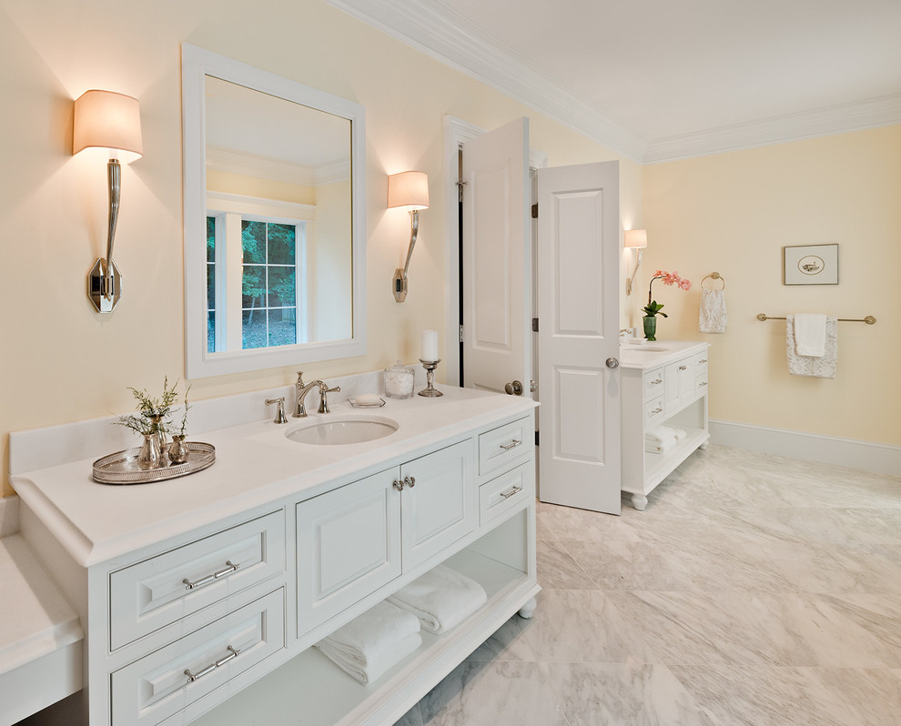 Design ideas for a bathroom in DC Metro with beaded inset cabinets, white cabinets, a freestanding tub, a double shower, a two-piece toilet, stone tile, marble floors, an undermount sink and marble benchtops.
