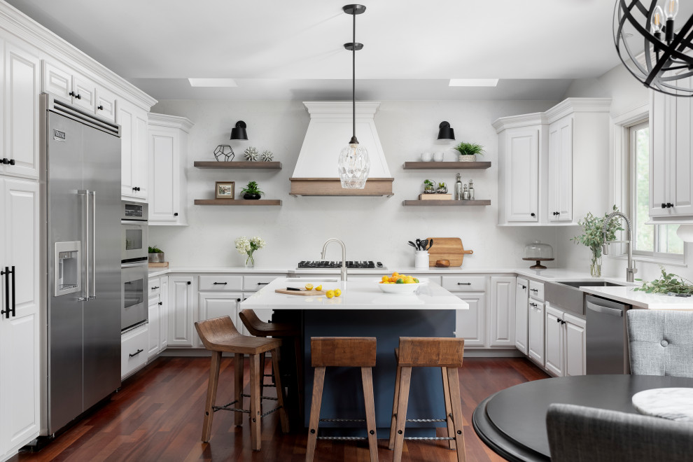 Example of a large transitional u-shaped medium tone wood floor and vaulted ceiling eat-in kitchen design in Chicago with a farmhouse sink, raised-panel cabinets, gray cabinets, quartz countertops, white backsplash, quartz backsplash, stainless steel appliances, an island and white countertops
