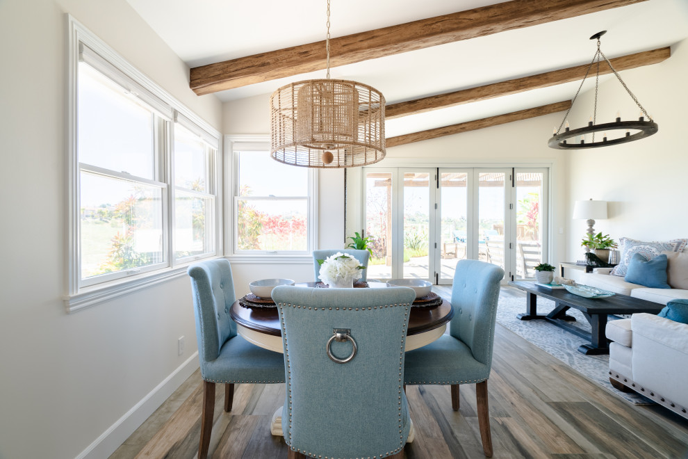 Inspiration for an expansive country open plan dining room in San Diego with porcelain flooring, brown floors and exposed beams.