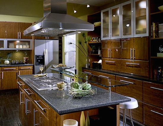 Inspiration for a mid-sized u-shaped ceramic tile eat-in kitchen remodel with dark wood cabinets, soapstone countertops, green backsplash, glass tile backsplash, stainless steel appliances and an island