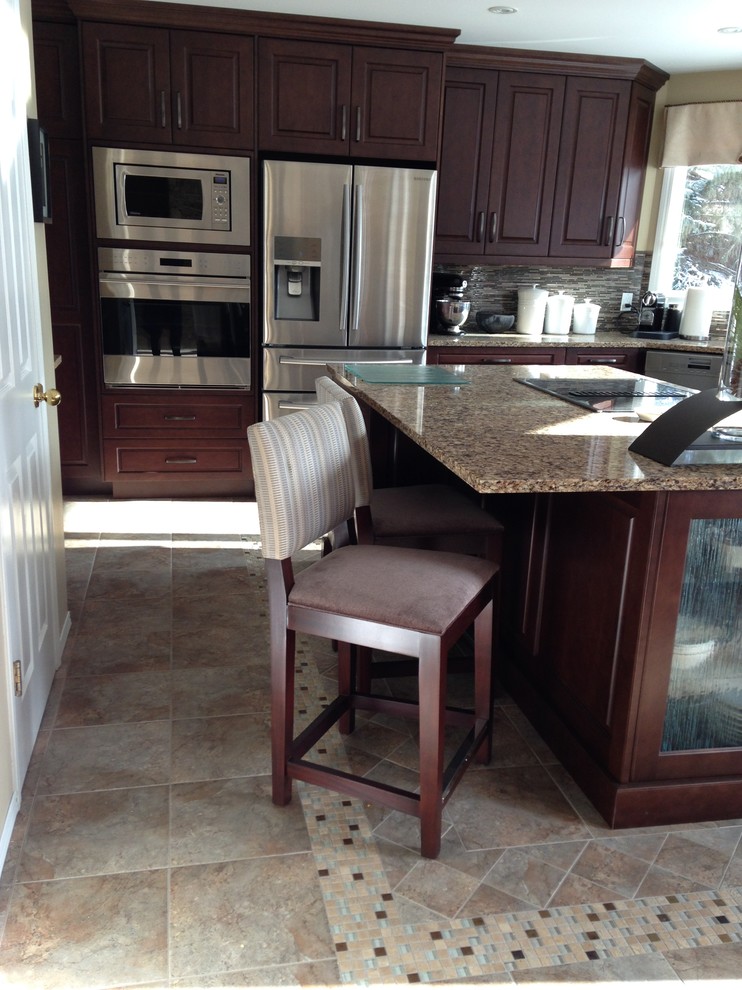 Example of a transitional u-shaped ceramic tile eat-in kitchen design in Edmonton with an undermount sink, raised-panel cabinets, medium tone wood cabinets, granite countertops, multicolored backsplash, matchstick tile backsplash, stainless steel appliances and an island