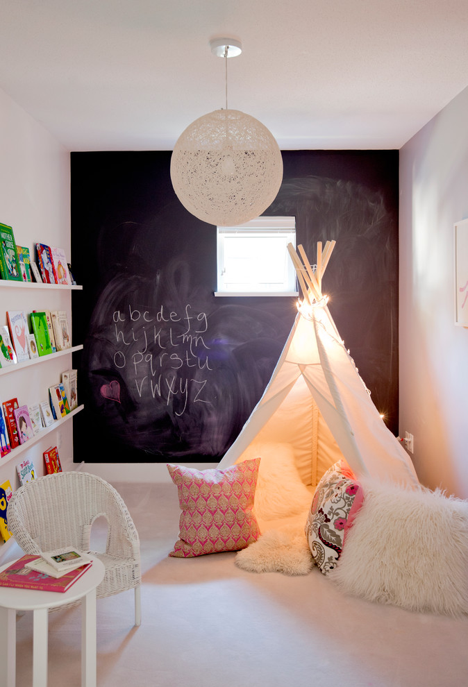 Design ideas for a small eclectic gender-neutral kids' playroom for kids 4-10 years old in Vancouver with carpet and multi-coloured walls.