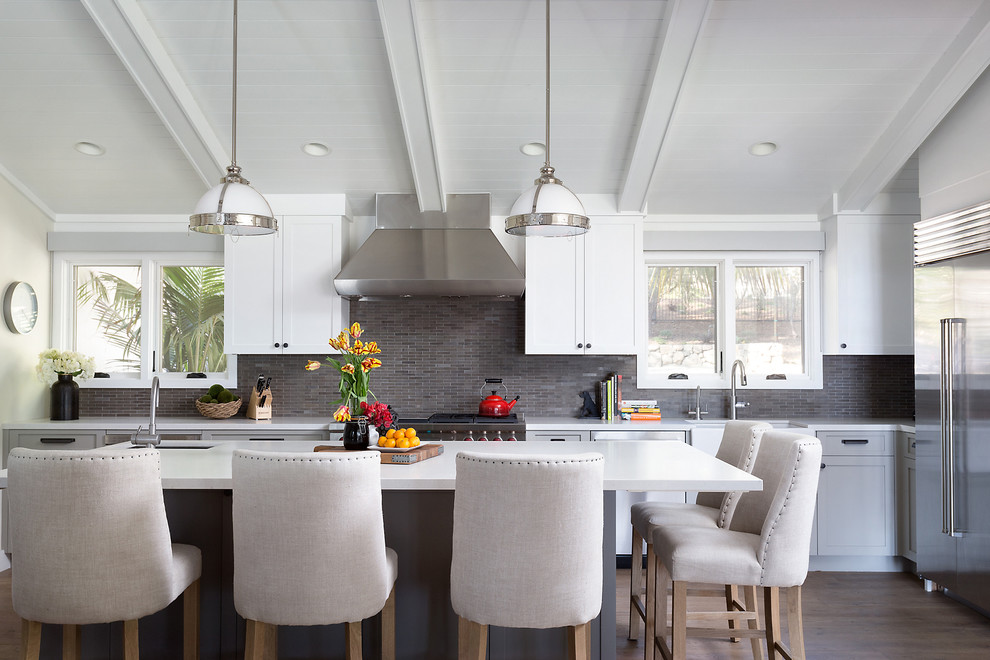 Design ideas for a transitional kitchen in Santa Barbara with shaker cabinets, white cabinets, grey splashback, stainless steel appliances, dark hardwood floors, with island, an undermount sink and mosaic tile splashback.