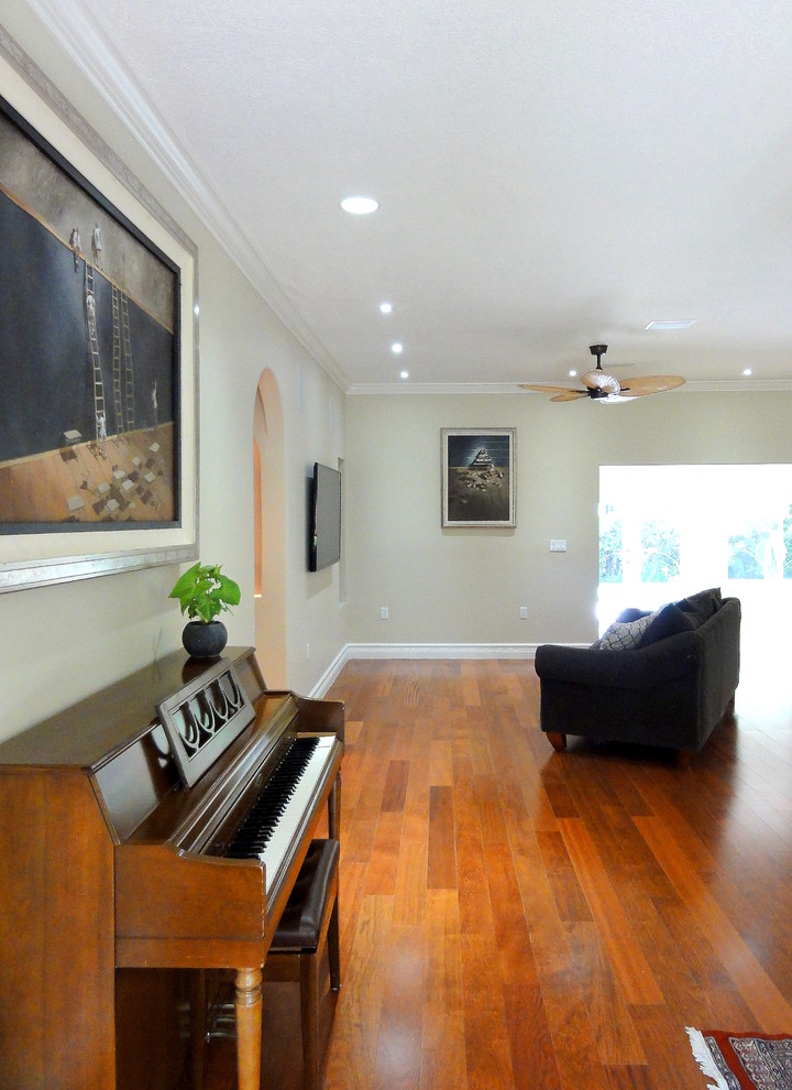 Photo of a mid-sized transitional open concept living room in Miami with beige walls, medium hardwood floors and a wall-mounted tv.